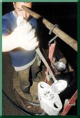 Marco Ernandes pouring molten zinc into bridge bowl.