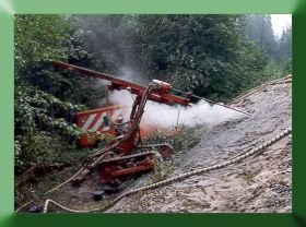 Drilling main anchor with air track drill