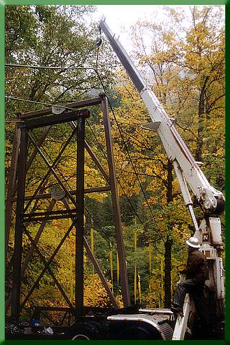 Returning original mainline to top of new steel tower; temporary tower in foreground.