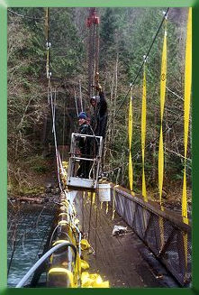 Su Thieda and Keith Monohan working from basket to install temporary suspenders.