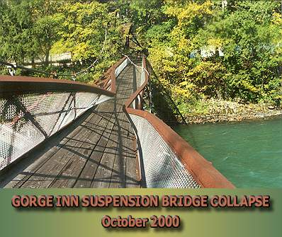 Collapsed bridge showing buckled top chords near mid-span and upriver mainline lying across bridge.  Note collapsed tower at far end.