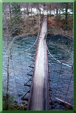View of bridge from top of surviving tower; temporary tower erected in distance.