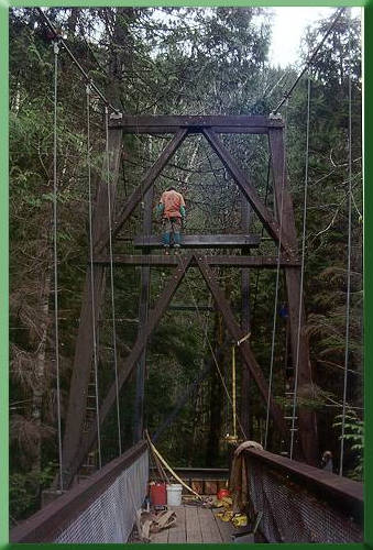 Final assembly of temporary tower:  hoisting top crossbeam in place.  Original tower in foreground.