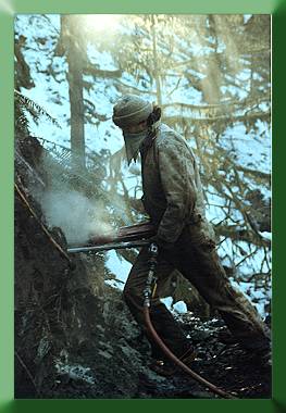 Carroll Vogel drilling rock for blast hole.