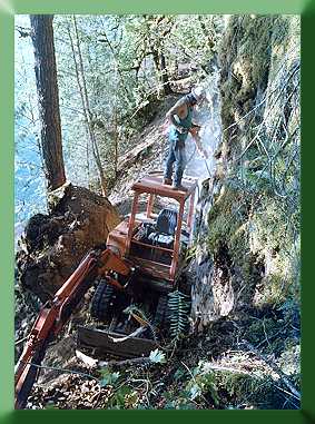 Roger Babcock drilling backslope from Kubota roof.
