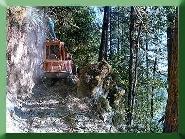 Roger Babcock drilling backslope from Kubota roof.