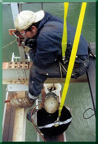 Keith Monohan and Jim Lemieux installing splice plate/sway cable attachment.