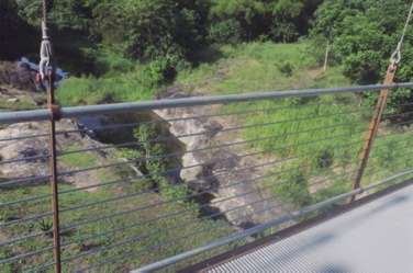 The Caguitas River through cable barrier.