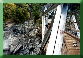 Carroll Vogel working in harness to attach temporary suspenders.