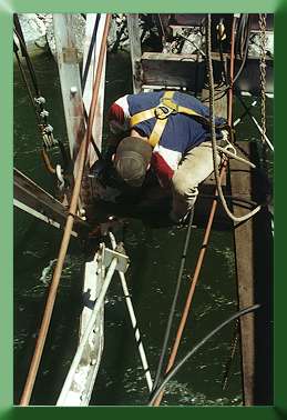 Keith Monohan cutting old diagonal braces free with plasma cutter.