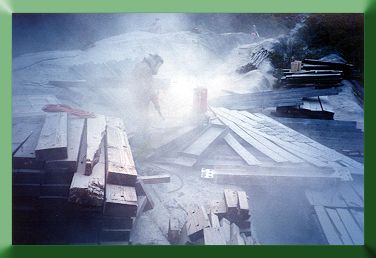 Sandblasting, using sand from nearby beach.