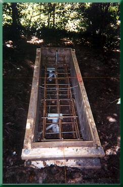 Abutment form showing tops of helical anchors and rebar cage prior to concrete placement.