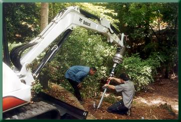 Checking batter of helical anchor for main cable.