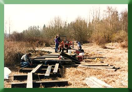 Crew laying stringers and decking.