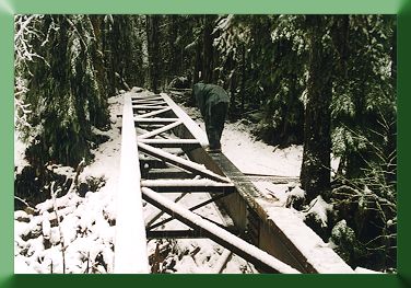 Cleaning snow from Blum Creek Bridge before decking.