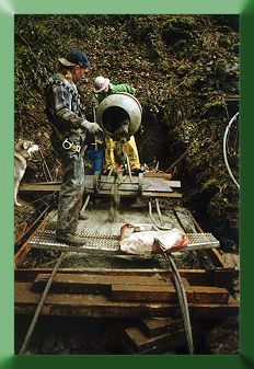 Keith Jellerson and Roger Babcock mixing and pouring concrete for the new tower footing.