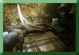 Keith Jellerson finishing the concrete.  Note that the mainlines are temporarily supported above the concrete by timbers.